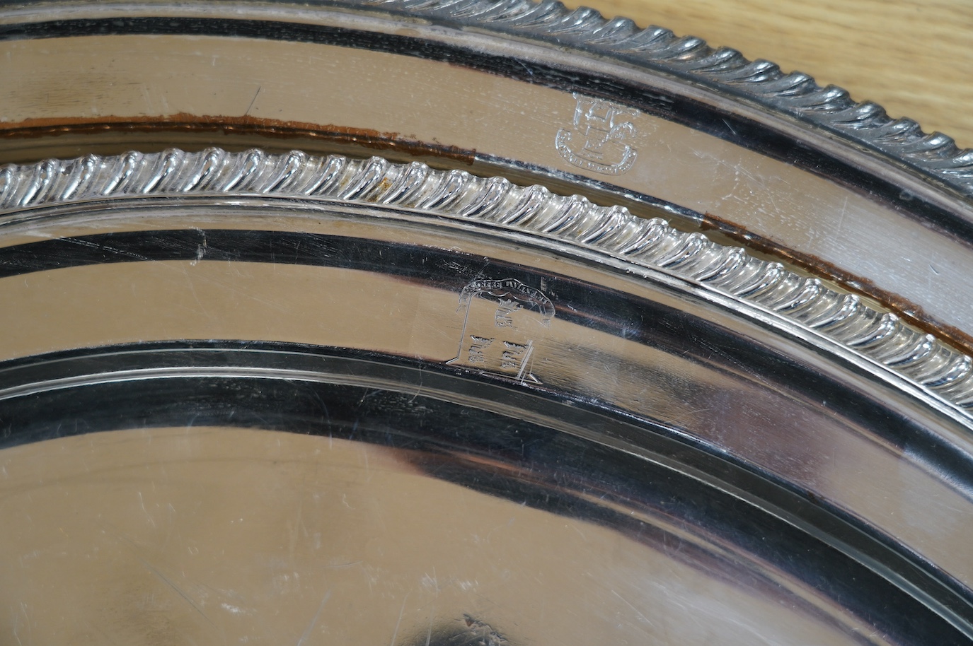 Two 19th century Old Sheffield plate oval meat plates, with gadrooned borders, largest 58.2cm. Condition - plate worn and scratched